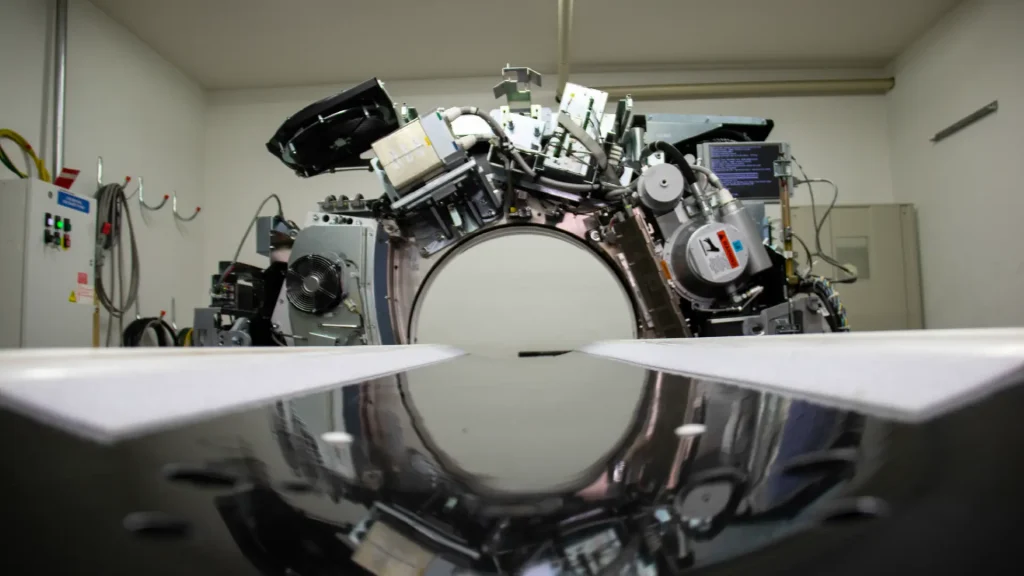 Close-up of an open CT scanner gantry showing internal components during reconditioning
