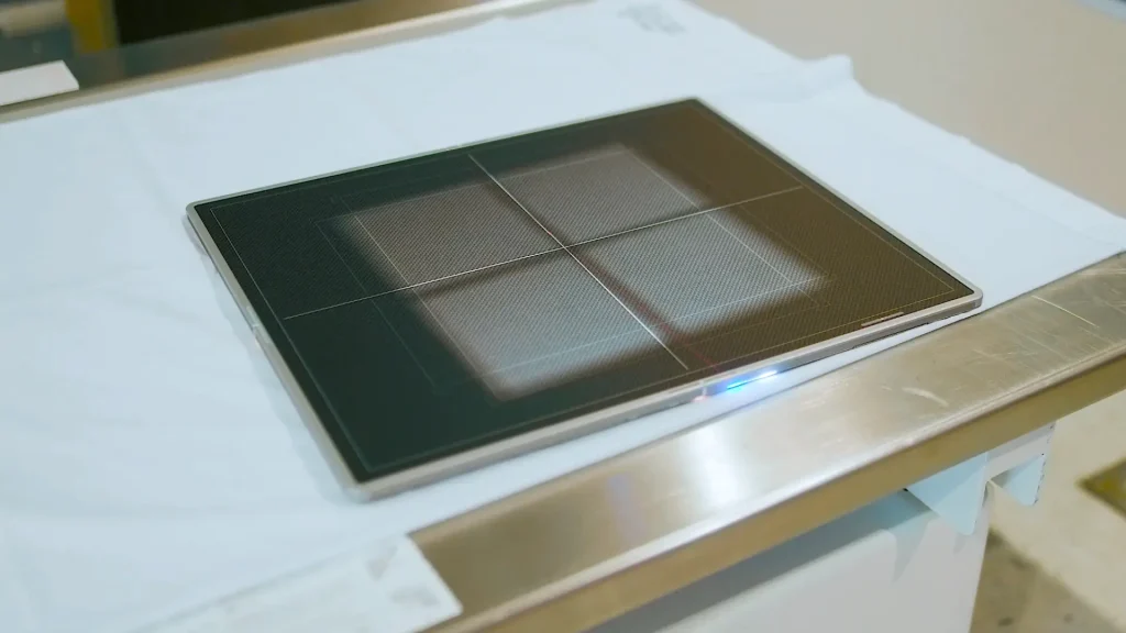 Close-up of a digital radiography flat-panel detector plate on an exam table during a DR upgrade at Decatur Health