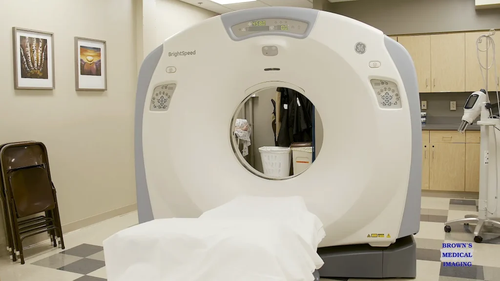 GE BrightSpeed CT scanner in an exam room with a patient table, reconditioned and installed at Comanche County Hospital