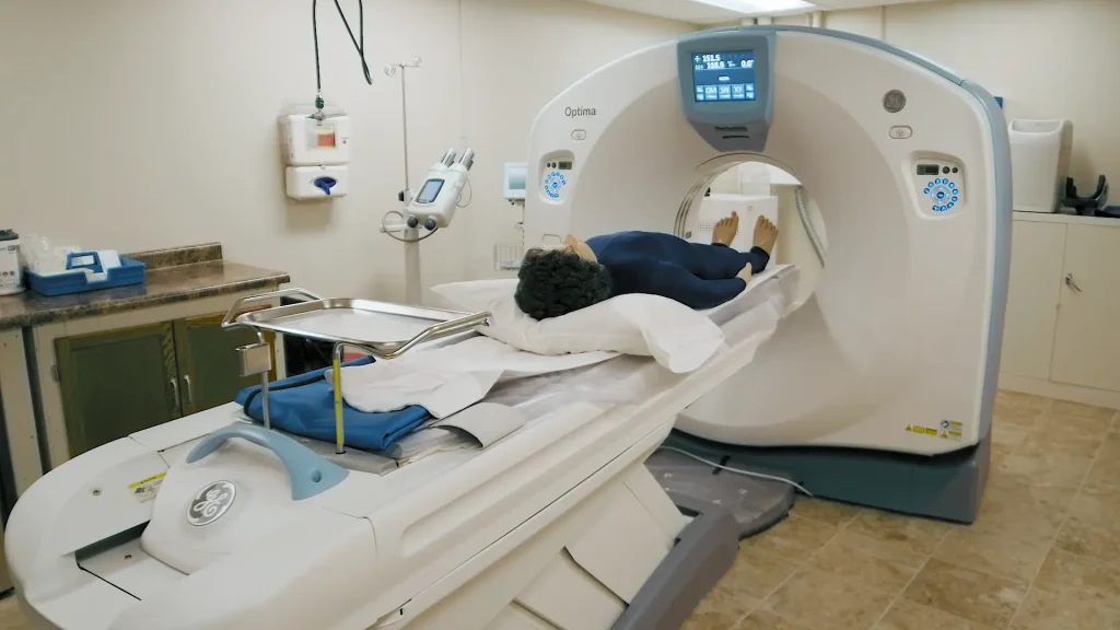Patient undergoing a scan in a GE Optima 660 CT scanner, feet first on the table