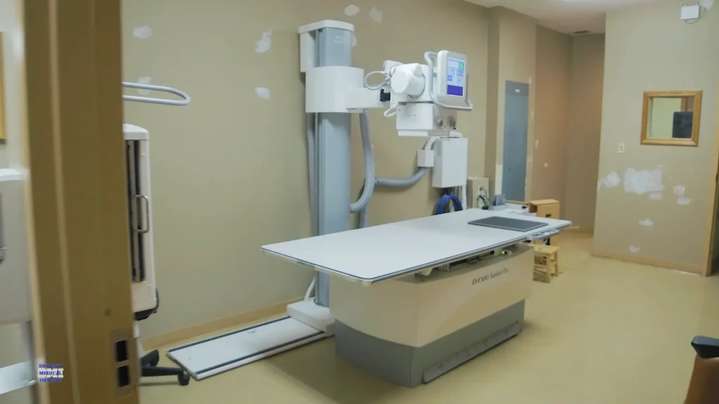 Fujifilm D-EVO Suite FSx X-ray system with overhead tube column and imaging table in an exam room under renovation