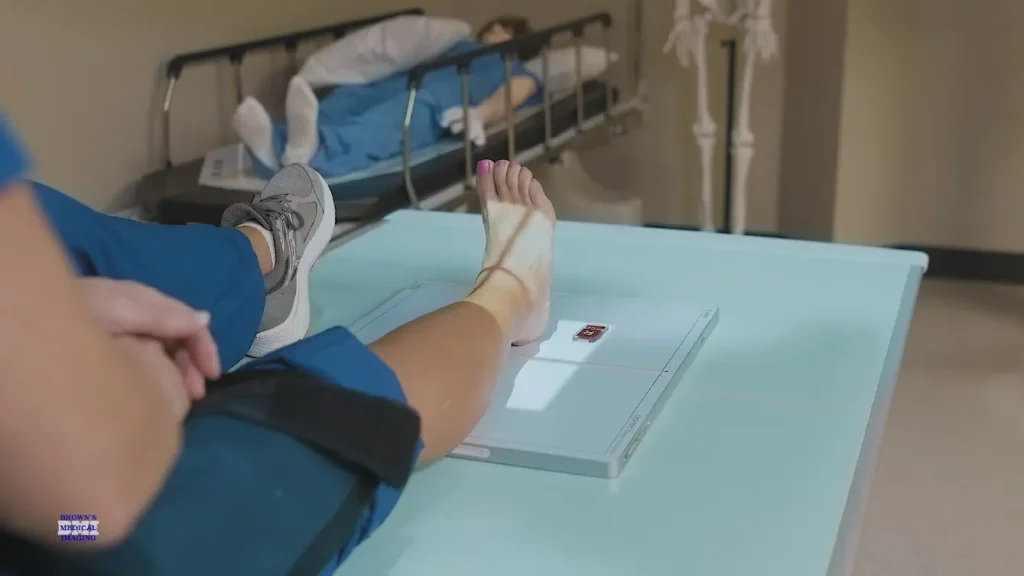 Close-up of a patient's ankle and foot positioned on an X-ray table detector panel for an ankle X-ray