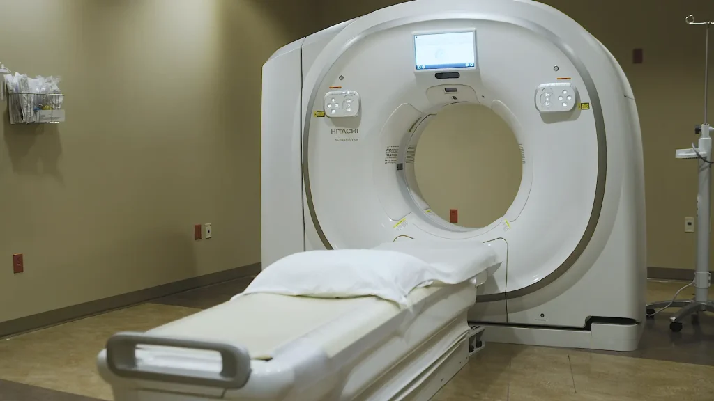 Hitachi Scenaria View CT scanner with wide-bore gantry and patient table in an exam room