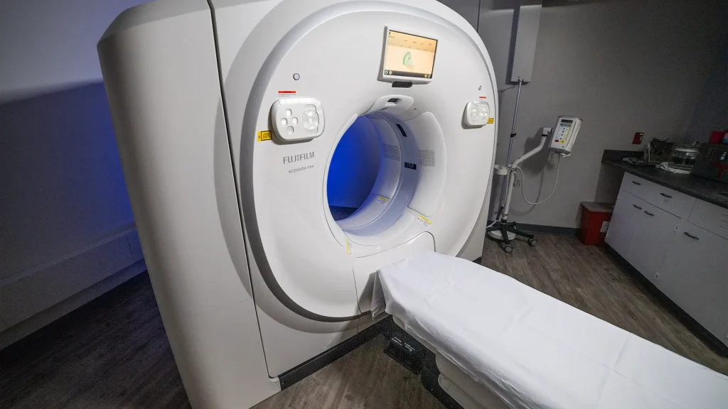 Fujifilm Scenaria View CT scanner with illuminated blue bore opening in an exam room