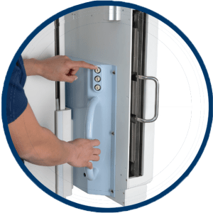 Close-up of hands operating the detector handle and button controls on the Acuity FDR+ system