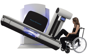 Illustration of a patient in a wheelchair positioning at the Persona RF PREMIUM table and wall stand