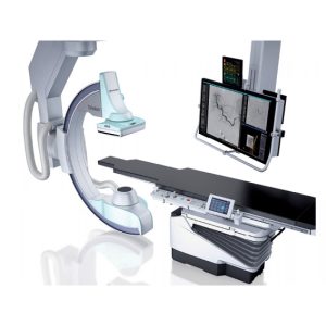 Canon Trinias interventional imaging system showing the C-arm, exam table, and dual monitors displaying angiographic images