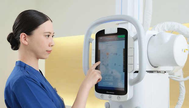 Technologist using the touchscreen tube head console on the RADspeed Pro SR5 X-ray system