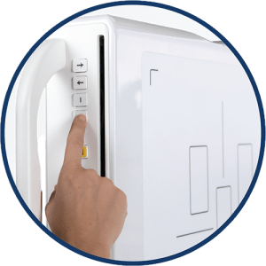 Close-up of a hand pressing a control button on the side panel of an Acuity SDR+ system