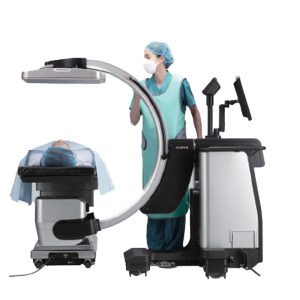 Fujifilm FDR Cross mobile C-arm system in use in an operating room, with a clinician and draped patient on the table