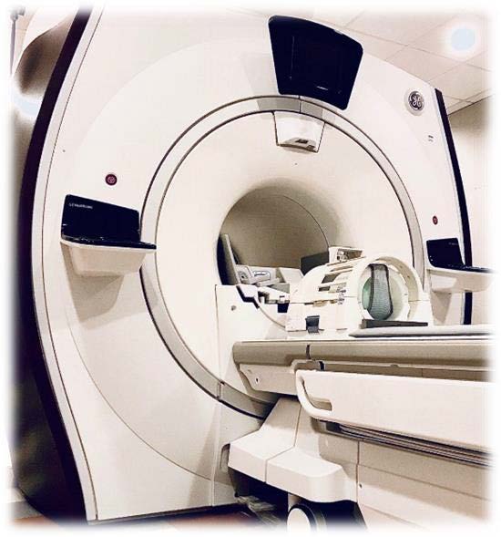 Refurbished GE MRI scanner bore and patient table in an exam room
