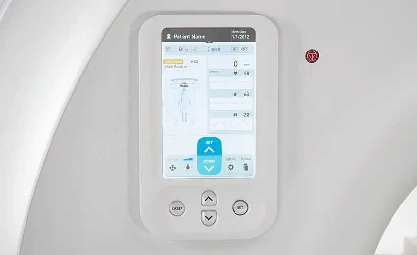 Close-up of the Echelon Synergy MRI operator touchscreen panel showing patient info, brain scan routine, and vital sign monitors