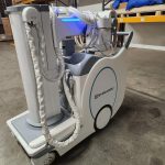 Shimadzu mobile X-ray unit, side view with tube head illuminated in warehouse