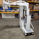 Shimadzu mobile X-ray unit, rear side view showing tube arm and column in warehouse