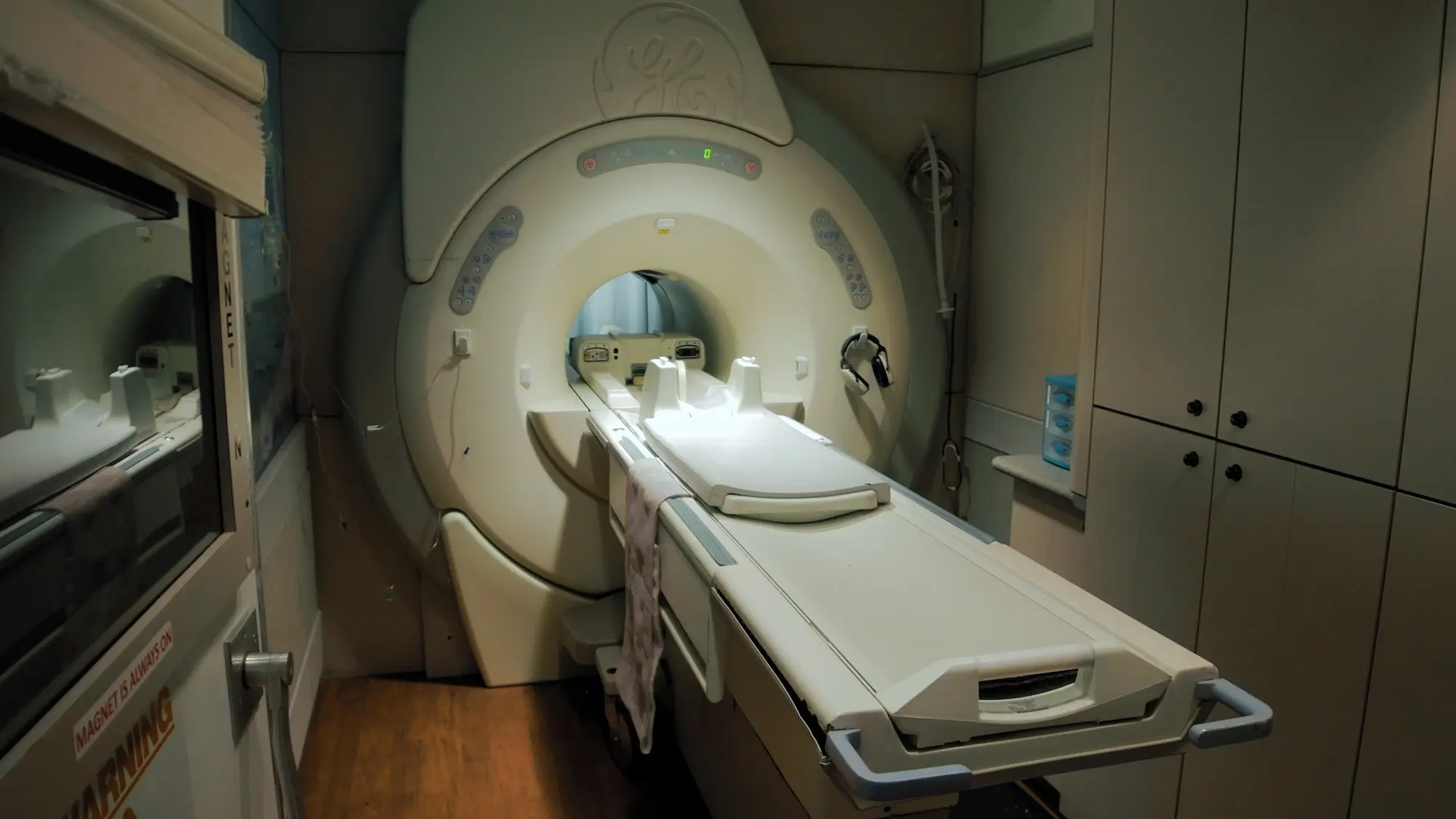 GE HDxT MRI scanner in a veterinary exam room with the patient table extended