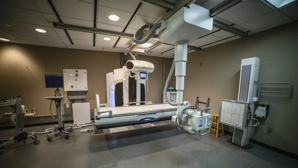 Fujifilm Persona RF digital fluoroscopy room with imaging table, tube stand, and wall-mounted detector