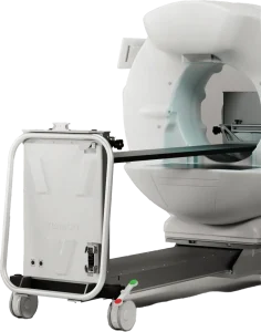Vimago cone beam CT scanner gantry with the sliding patient table extended through the bore