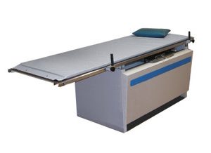 Gray economy radiolucent X-ray table pad on a table base, with a small positioning cushion