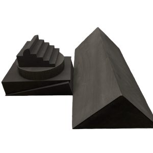 Bundle of dark gray closed cell foam positioning sponges, including a stepped headrest and a large wedge